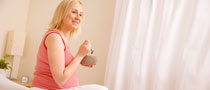 Pregnant woman sitting and eating