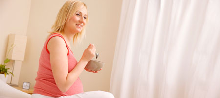 Pregnant woman sitting and eating
