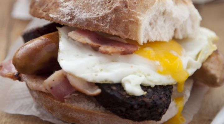 Simple sausage, bacon and egg sandwich