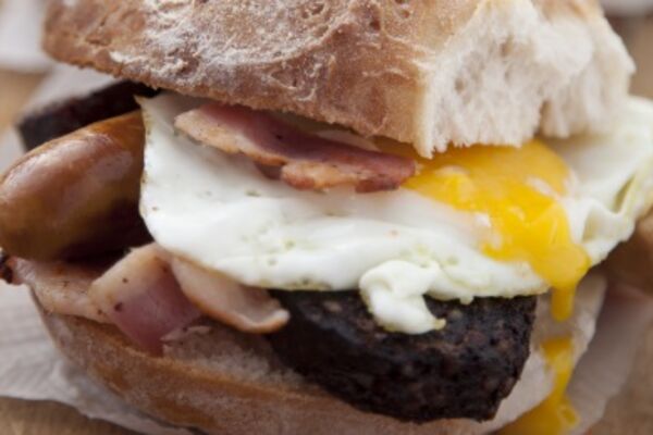 Simple sausage, bacon and egg sandwich